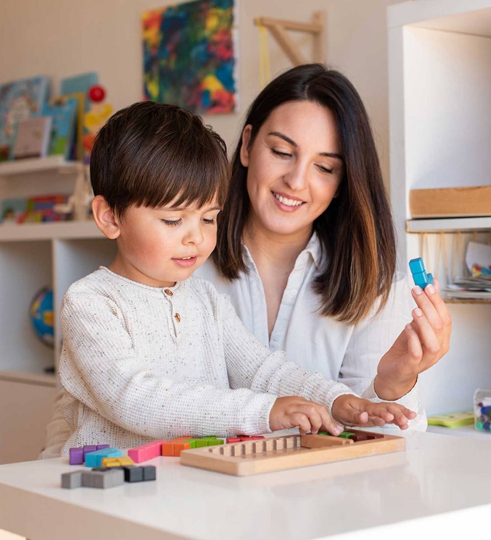 kid-playing-with-a-tetris-wood-puzzle-and-mother